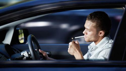Driver lights cigarette