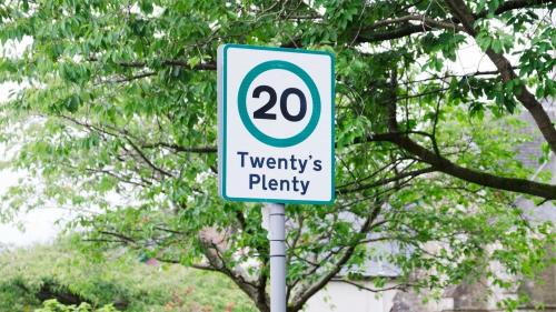 Speed limit sign in green circle 3